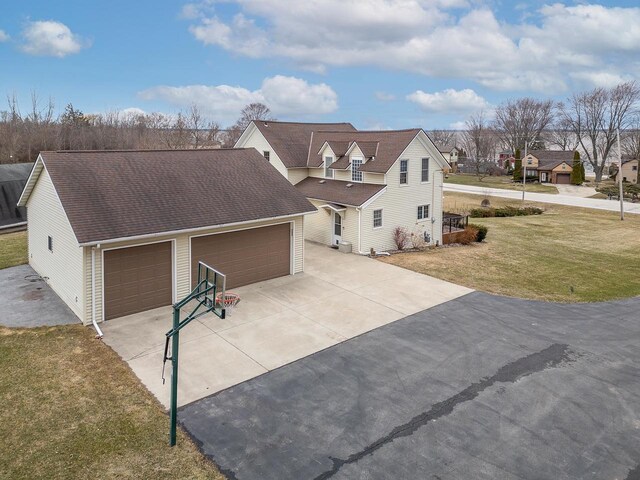 3304 Nicolet Dr, Green Bay, WI 54311 - exterior space with an attached garage, roof with shingles, concrete driveway, and a yard