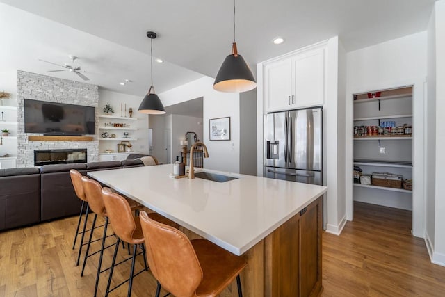 150551 Lavender Ln, Wausau, WI 54401 - kitchen with a ceiling fan, a sink, stainless steel refrigerator with ice dispenser, and light wood-type flooring
