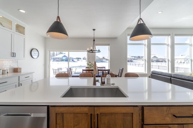 150551 Lavender Ln, Wausau, WI 54401 - kitchen with brown cabinets, light countertops, a sink, and a healthy amount of sunlight