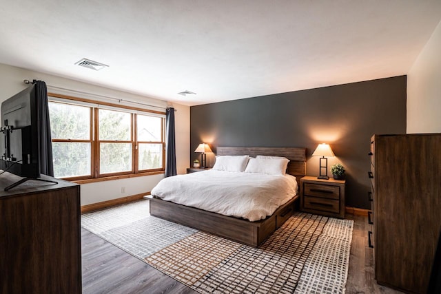 4824 Hampton Ct, Mount Pleasant, WI 53403 - bedroom with baseboards, wood finished floors, and visible vents