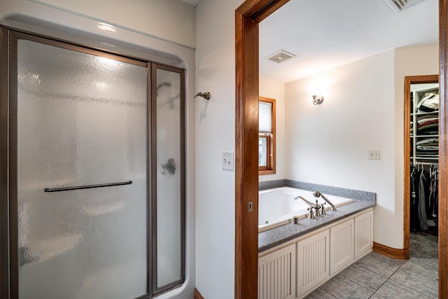 4824 Hampton Ct, Mount Pleasant, WI 53403 - full bathroom with a shower stall, a spacious closet, tile patterned flooring, and a jetted tub