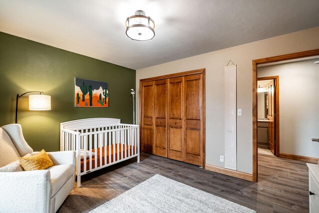 4824 Hampton Ct, Mount Pleasant, WI 53403 - bedroom with wood finished floors, a closet, a crib, and baseboards