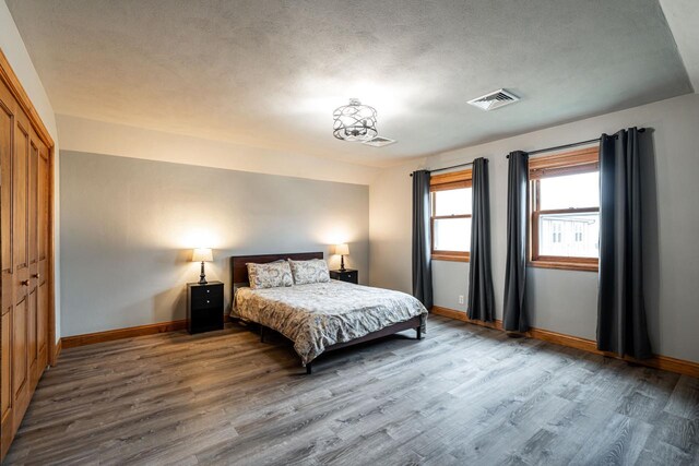 4824 Hampton Ct, Mount Pleasant, WI 53403 - bedroom featuring baseboards, wood finished floors, visible vents, and a closet