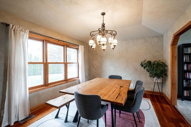 4824 Hampton Ct, Mount Pleasant, WI 53403 - dining room with a textured ceiling, wood finished floors, visible vents, and a notable chandelier