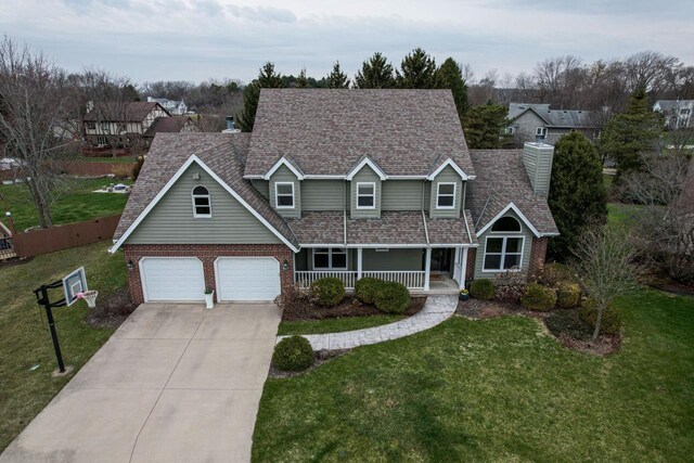 4824 Hampton Ct, Mount Pleasant, WI 53403 - traditional home featuring concrete driveway, a front lawn, brick siding, and a porch