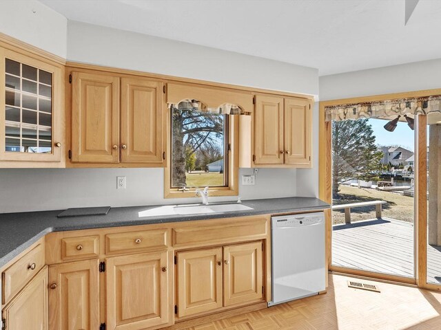 535 E Vine Ct, Sturgeon Bay, WI 54235 - kitchen featuring light brown cabinets, dark countertops, a sink, and white dishwasher