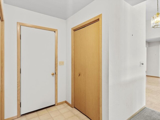 535 E Vine Ct, Sturgeon Bay, WI 54235 - corridor with baseboards and an inviting chandelier