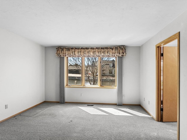 535 E Vine Ct, Sturgeon Bay, WI 54235 - carpeted empty room with baseboards, visible vents, and a textured ceiling