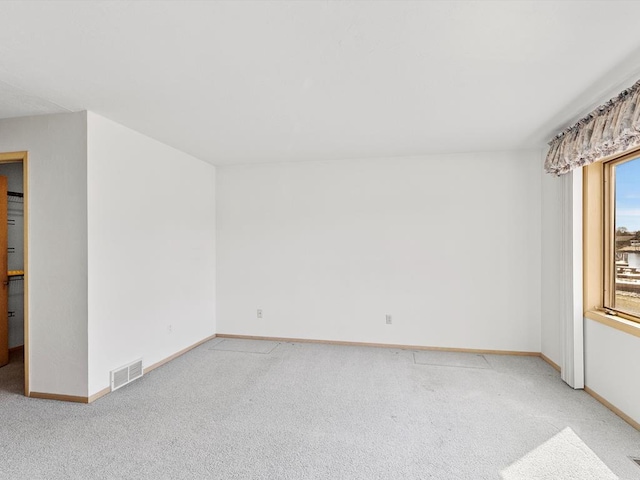 535 E Vine Ct, Sturgeon Bay, WI 54235 - empty room with baseboards, visible vents, and light colored carpet