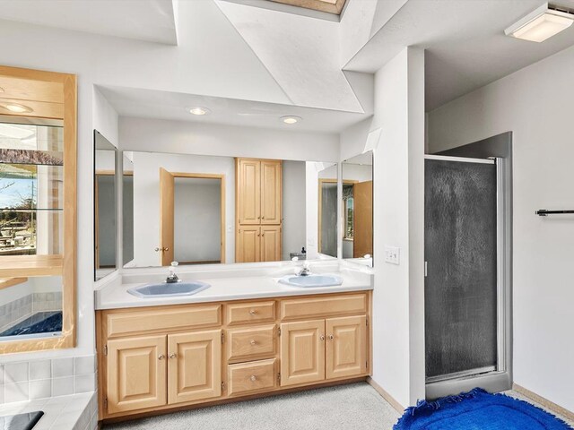 535 E Vine Ct, Sturgeon Bay, WI 54235 - bathroom featuring baseboards, double vanity, a sink, and a shower stall