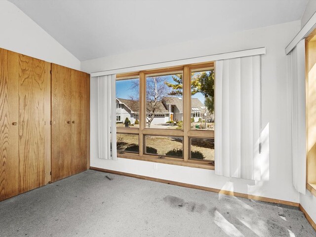 535 E Vine Ct, Sturgeon Bay, WI 54235 - unfurnished room featuring carpet, lofted ceiling, and baseboards