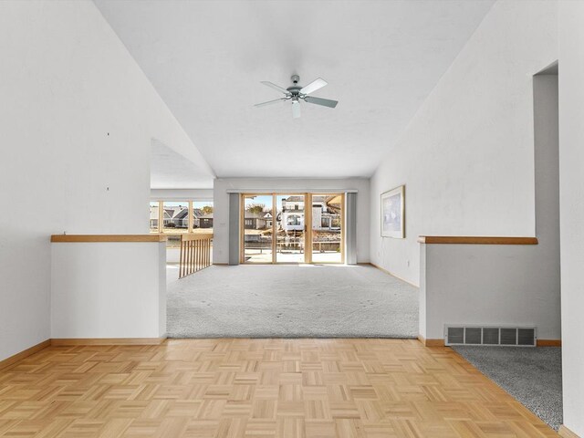 535 E Vine Ct, Sturgeon Bay, WI 54235 - unfurnished living room featuring a towering ceiling, baseboards, visible vents, and ceiling fan