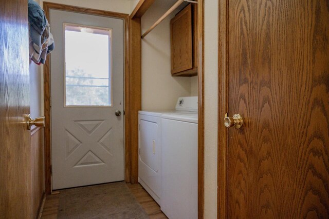 N9656 19th Ave, Necedah, WI 54646 - laundry area with washing machine and clothes dryer, cabinet space, and light wood-style floors
