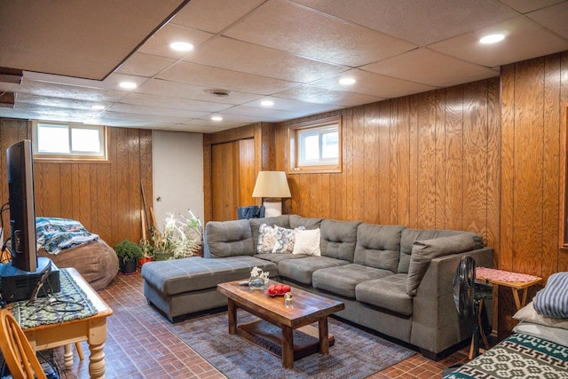 N9656 19th Ave, Necedah, WI 54646 - living area featuring a wealth of natural light, wooden walls, visible vents, and brick patterned floor