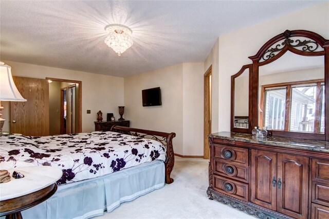 4330 S Pointe Ct, Eau Claire, WI 54701 - bedroom with an inviting chandelier, light colored carpet, and baseboards