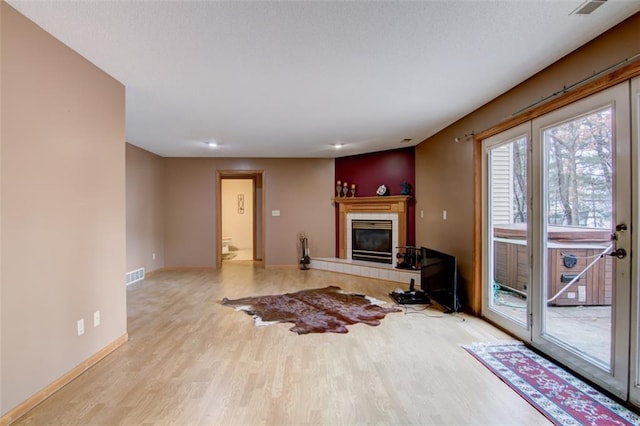4330 S Pointe Ct, Eau Claire, WI 54701 - unfurnished living room with visible vents, baseboards, a tiled fireplace, recessed lighting, and wood finished floors