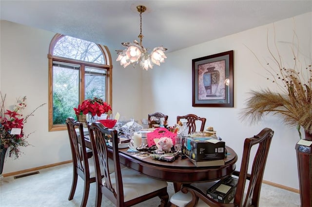 4330 S Pointe Ct, Eau Claire, WI 54701 - dining area with light carpet, an inviting chandelier, baseboards, and visible vents