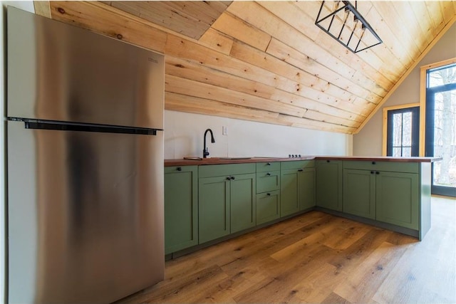 61128 Fleming Loop, Askov, MN 55704 - kitchen with green cabinetry, light wood-style floors, wood ceiling, and freestanding refrigerator