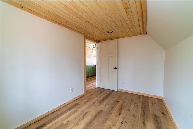 61128 Fleming Loop, Askov, MN 55704 - unfurnished room with baseboards, light wood-type flooring, wooden ceiling, and vaulted ceiling
