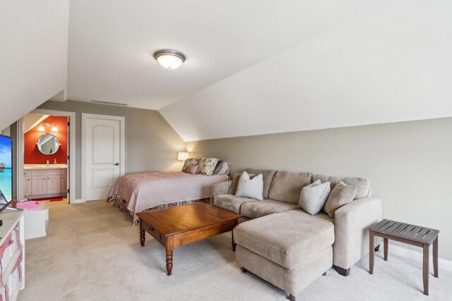 S51W29202 Ridgefield Rd, Waukesha, WI 53189 - bedroom with vaulted ceiling, light carpet, ensuite bath, visible vents, and a sink