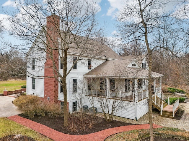 S51W29202 Ridgefield Rd, Waukesha, WI 53189 - view of front of house with a porch, roof with shingles, a chimney, and central AC unit