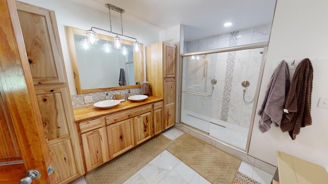 26350 Drake Ln, Cazenovia, WI 53924 - bathroom featuring marble finish floor, vanity, tasteful backsplash, and a shower stall