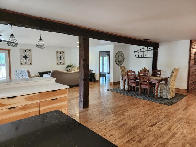 26350 Drake Ln, Cazenovia, WI 53924 - dining room featuring baseboards, beam ceiling, and light wood finished floors