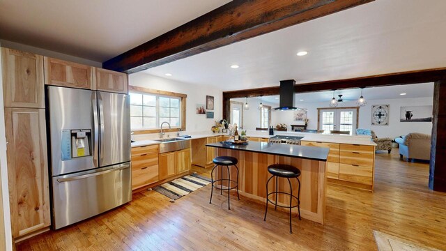 26350 Drake Ln, Cazenovia, WI 53924 - kitchen with a sink, stainless steel refrigerator with ice dispenser, light brown cabinetry, and island exhaust hood