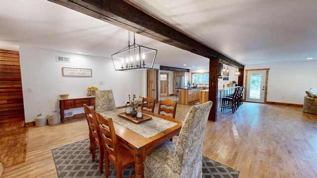 26350 Drake Ln, Cazenovia, WI 53924 - dining room with light wood finished floors, baseboards, visible vents, and beam ceiling