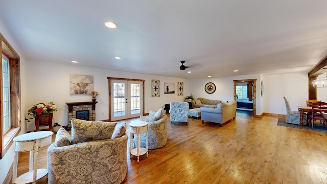 26350 Drake Ln, Cazenovia, WI 53924 - living room with ceiling fan, recessed lighting, light wood-type flooring, and a stone fireplace