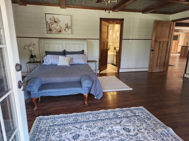 26350 Drake Ln, Cazenovia, WI 53924 - bedroom with ensuite bath, wood finished floors, baseboard heating, and beam ceiling