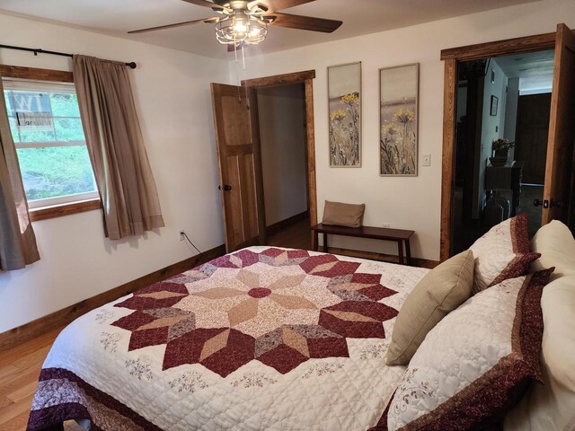 26350 Drake Ln, Cazenovia, WI 53924 - bedroom with a ceiling fan, baseboards, and wood finished floors