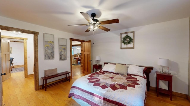 26350 Drake Ln, Cazenovia, WI 53924 - bedroom featuring baseboards, light wood-style flooring, and a ceiling fan