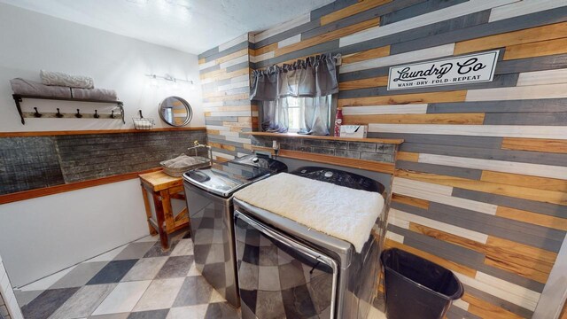 26350 Drake Ln, Cazenovia, WI 53924 - bathroom featuring washer and clothes dryer and wood walls