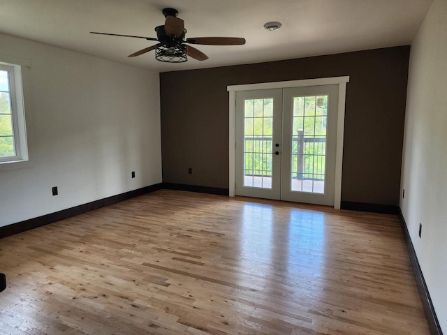 26350 Drake Ln, Cazenovia, WI 53924 - spare room with french doors, a ceiling fan, baseboards, and wood finished floors