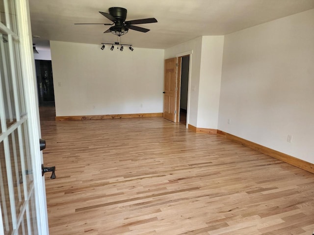 26350 Drake Ln, Cazenovia, WI 53924 - unfurnished room featuring baseboards, track lighting, light wood-style floors, and ceiling fan