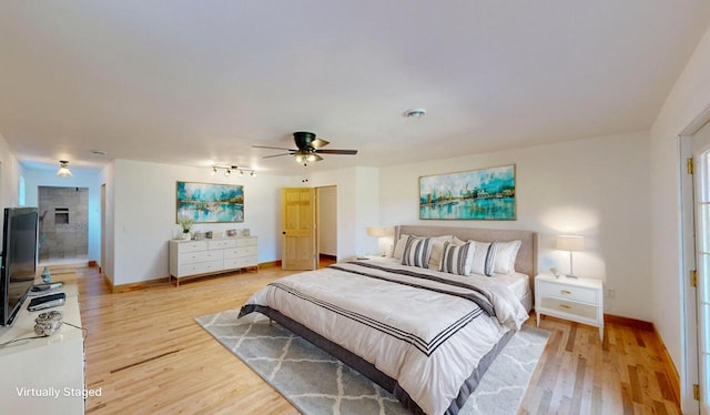 26350 Drake Ln, Cazenovia, WI 53924 - bedroom with baseboards, visible vents, ceiling fan, and light wood-style flooring