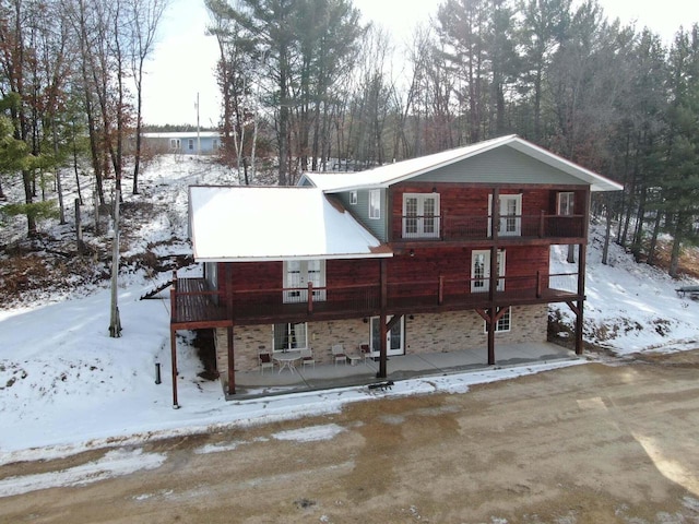 26350 Drake Ln, Cazenovia, WI 53924 - view of front facade featuring stone siding and a patio