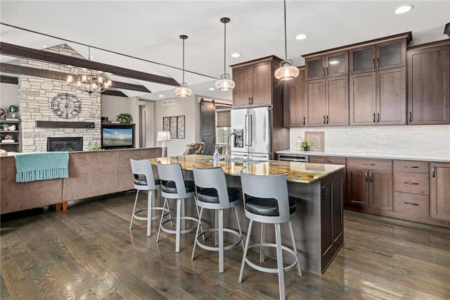 438 Highland Vw, Houlton, WI 54082 - kitchen featuring a kitchen breakfast bar, high end refrigerator, open floor plan, and dark wood-type flooring