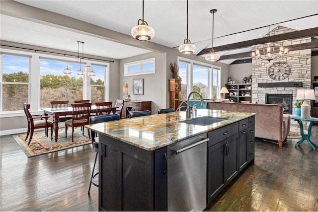 438 Highland Vw, Houlton, WI 54082 - kitchen with a sink, dark wood-style flooring, dark cabinets, stainless steel dishwasher, and open floor plan