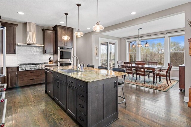 438 Highland Vw, Houlton, WI 54082 - kitchen with wall chimney exhaust hood, a sink, stainless steel appliances, and dark wood finished floors
