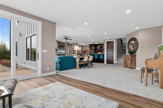 438 Highland Vw, Houlton, WI 54082 - living area with stairway, wood finished floors, a ceiling fan, and recessed lighting