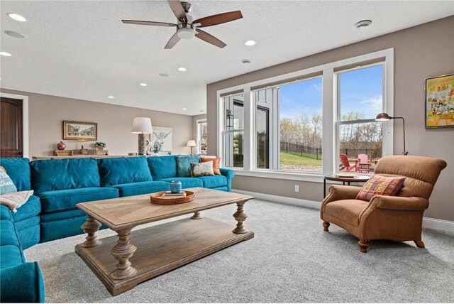 438 Highland Vw, Houlton, WI 54082 - carpeted living room featuring baseboards, recessed lighting, a ceiling fan, and a textured ceiling