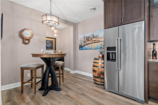 438 Highland Vw, Houlton, WI 54082 - dining space featuring light wood-style floors, a notable chandelier, and baseboards