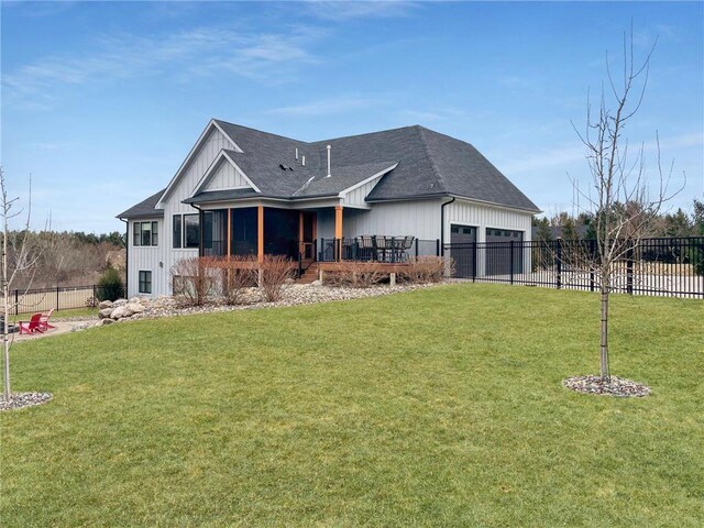 438 Highland Vw, Houlton, WI 54082 - view of front of home featuring fence, board and batten siding, a front yard, and a garage