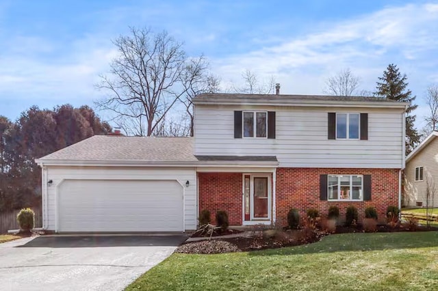 1800 Miller Rd, Lake Geneva, WI 53147 - traditional-style house featuring a front yard, brick siding, concrete driveway, and an attached garage