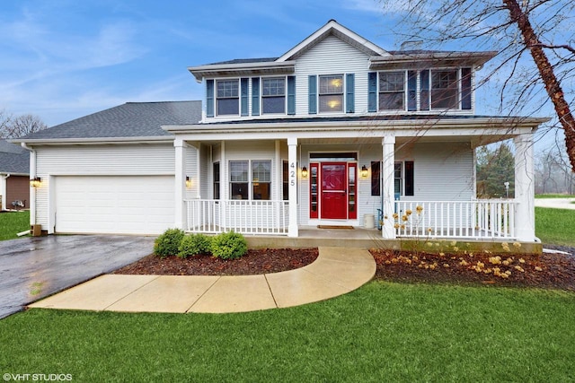 425 Maple Ln, Williams Bay, WI 53191 - traditional home featuring aphalt driveway, covered porch, a garage, and a front yard