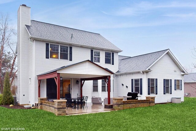 425 Maple Ln, Williams Bay, WI 53191 - rear view of house with a chimney, a lawn, a shingled roof, and a patio area