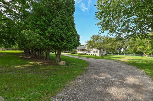 2855 N Shore Dr, Delavan, WI 53115 - view of front of home featuring fence, a front lawn, and curved driveway