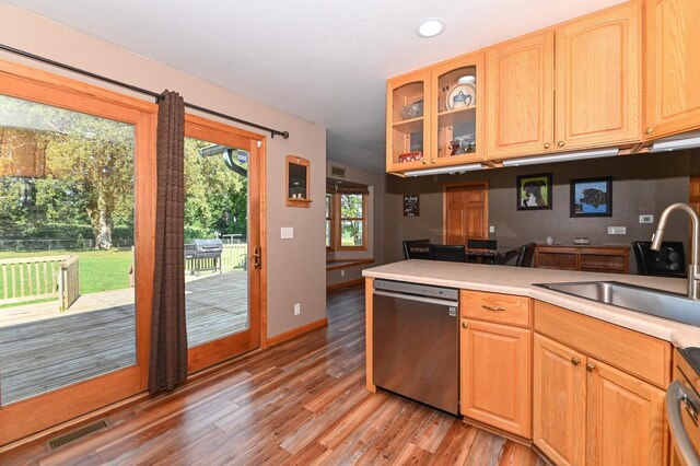 2855 N Shore Dr, Delavan, WI 53115 - kitchen with light wood-style flooring, visible vents, glass insert cabinets, a sink, and stainless steel dishwasher